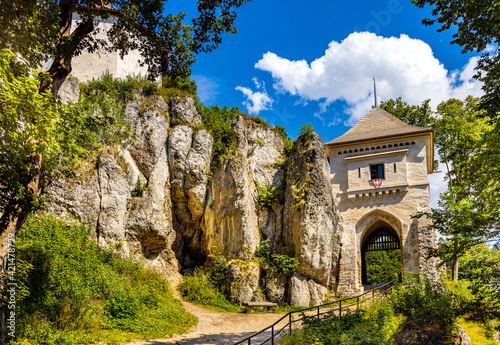 Gate tower and limestone rocky defense walls of medieval royal Ojcow Castle on Cracow-Czestochowa upland in Lesser Poland photo