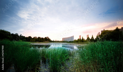 sunset over lake and buildings seen very far 