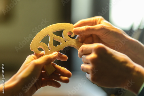 Fotografie Luthier violin maker working on wooden instrument with tools