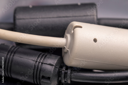 Close up of a ferrite bead inductor. An electrical element that suppresses high-frequency electronic noise in electronic circuits. photo