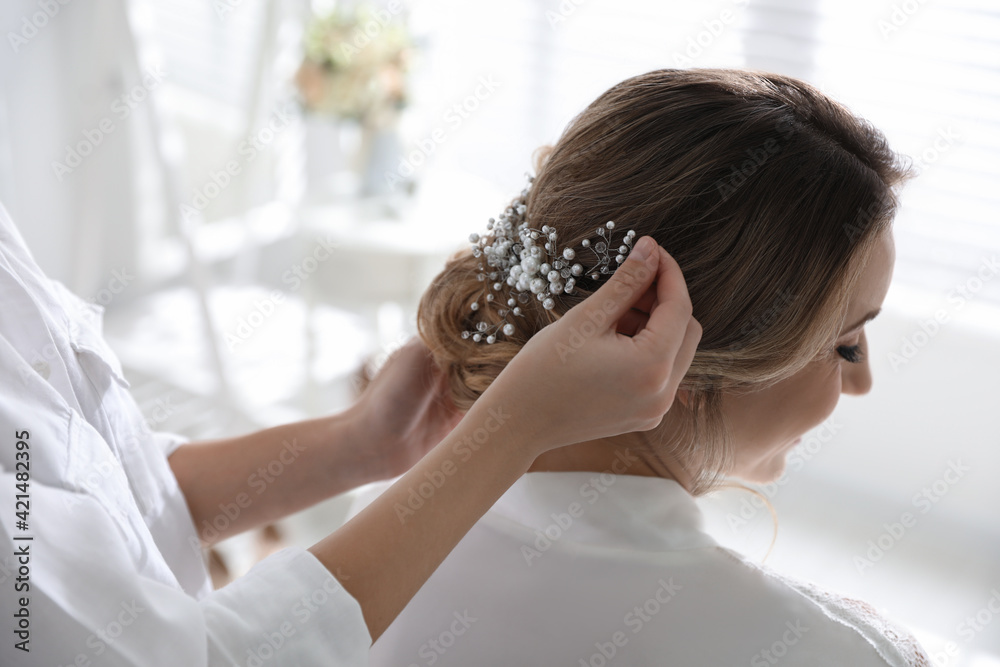 Professional stylist making wedding hairstyle for bride in salon Professional stylist making wedding hairstyle for bride in salon
