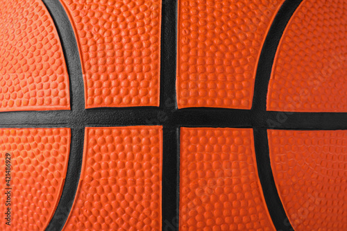 Orange ball as background, closeup. Basketball equipment © New Africa