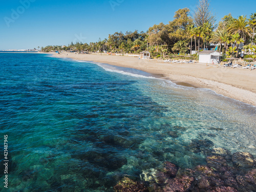 Turquoise sea with beautiful sand in Marbella photo