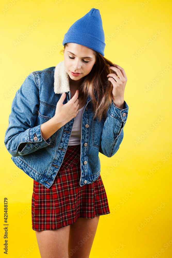 lifestyle people concept: pretty young school teenage girl having fun happy smiling on yellow background lifestyle people concept: pretty young school teenage girl having fun happy smiling on yellow background