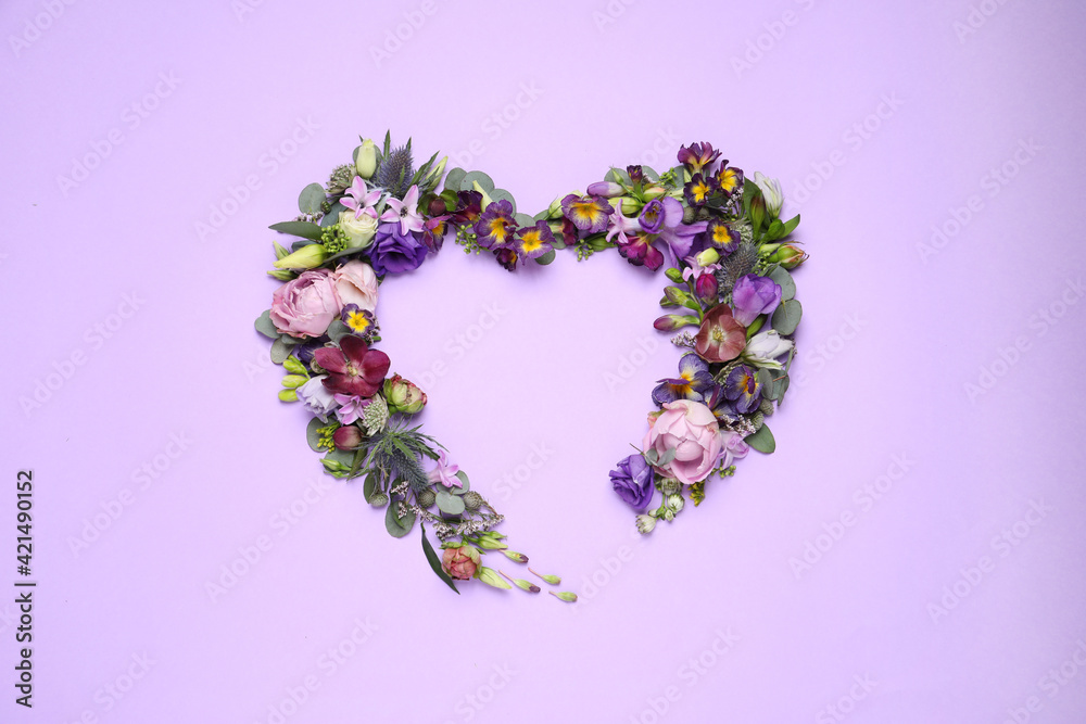 Beautiful heart made of different flowers on violet background, flat lay. Space for text