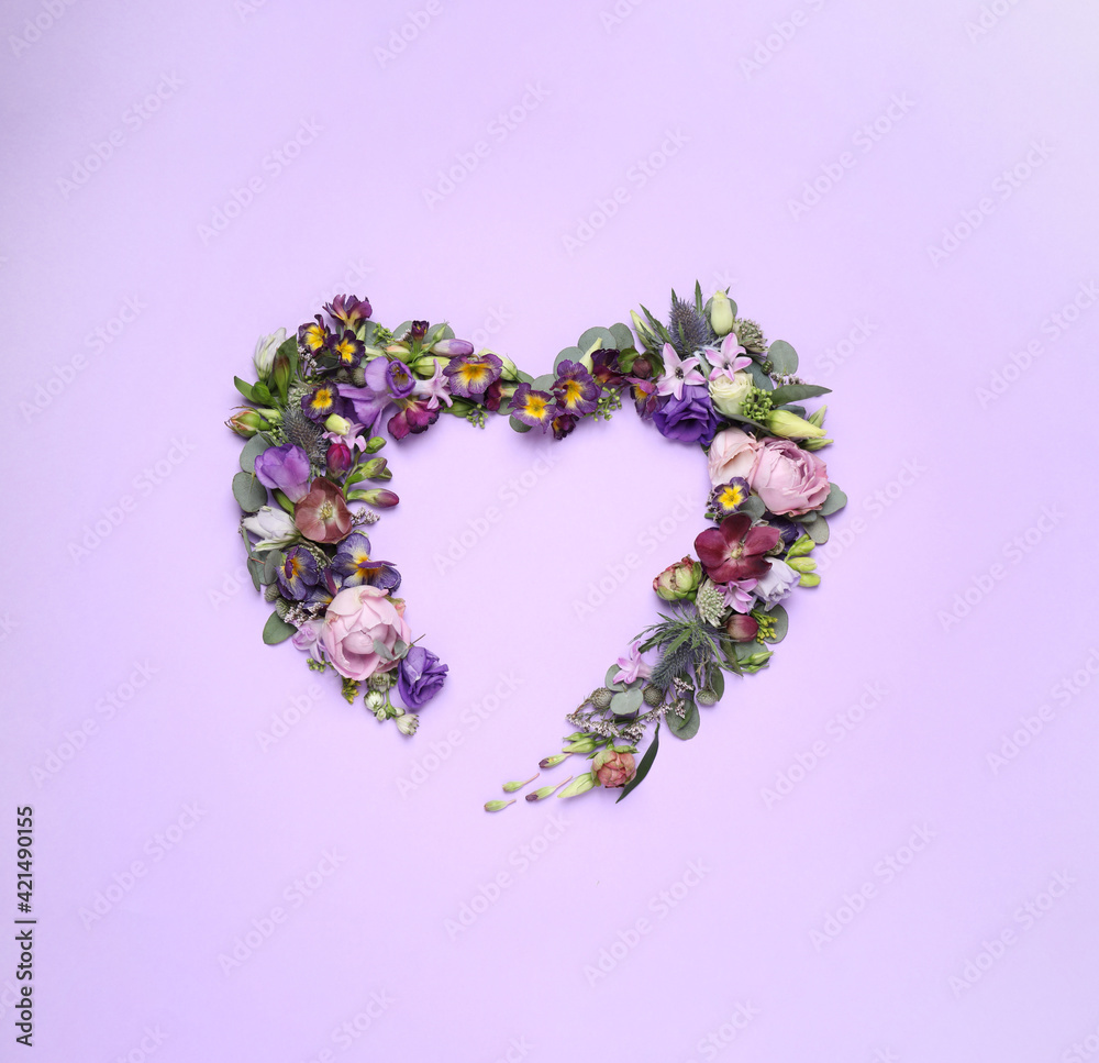 Beautiful heart made of different flowers on violet background, flat lay. Space for text Beautiful heart made of different flowers on violet background, flat lay. Space for text