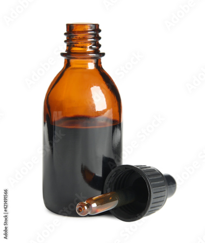 Bottle of medical iodine and dropper on white background photo