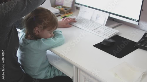 Wallpaper Mural Tired mother holding girl kid and using computer at home. Candid authentic and real life mom working and parenting Torontodigital.ca