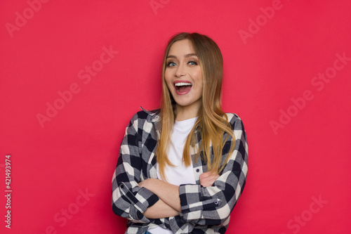 Happy Young Woman Is Posing With Arms Crossed And Shouting