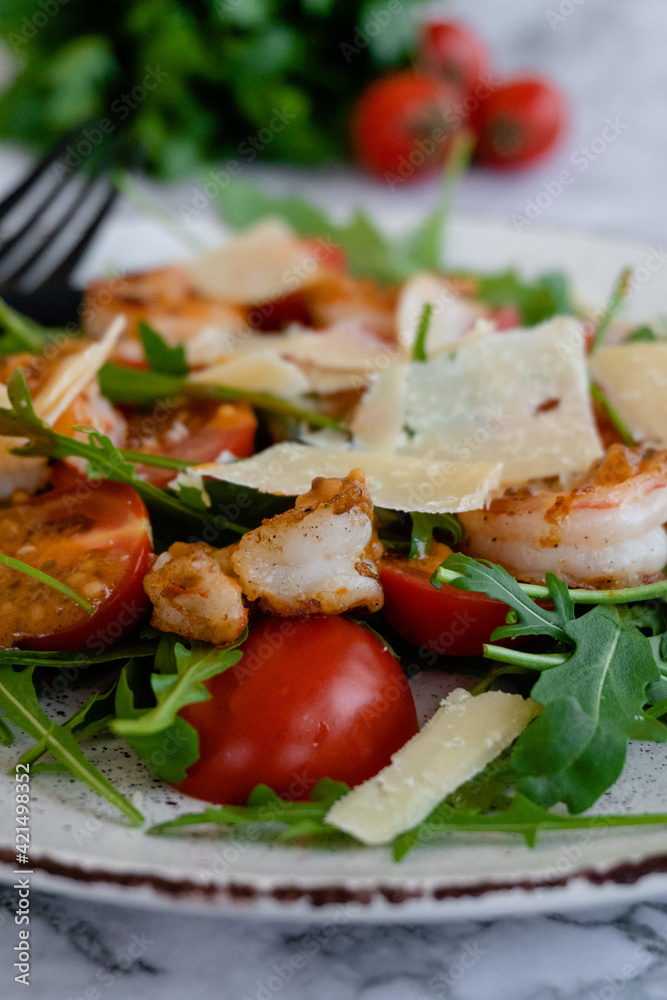 close up salad with arugula, shrimps and parmesan cheese