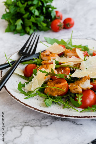 salad with arugula, shrimps and parmesan cheese