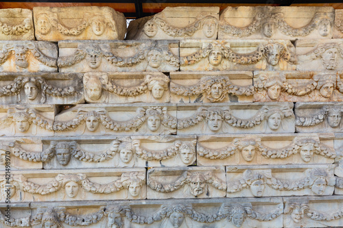 Sculptural frieze with theatre masks and portraits of gods and goddesses linked by garlands on Portico of Tiberius, Aphrodisias, Turkey