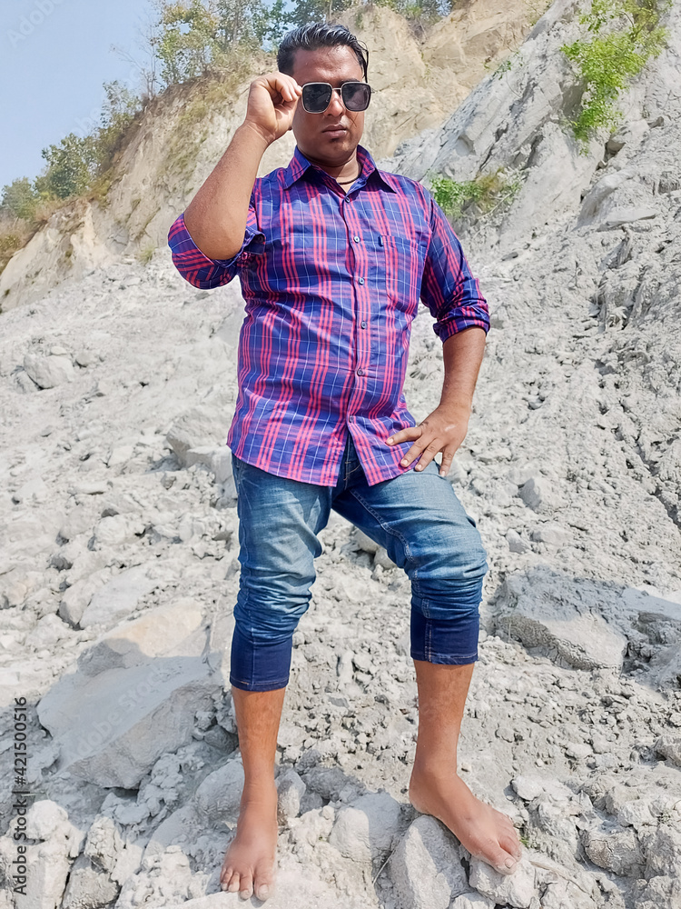 Handsome model man wearing colorful t-shirt with kosi river mountain beautiful background - obrazy, fototapety, plakaty 