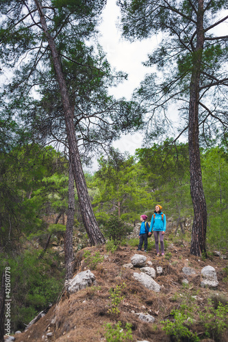 A child with his mother on a hike to the mountains