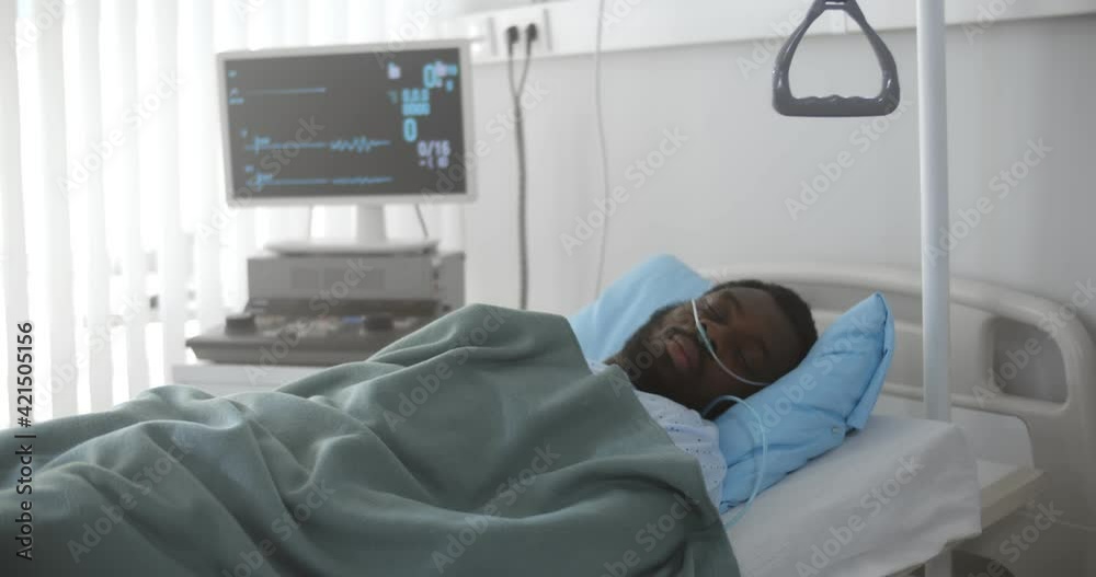 Portrait of afro-american man in coma dying in hospital bed with heart ...