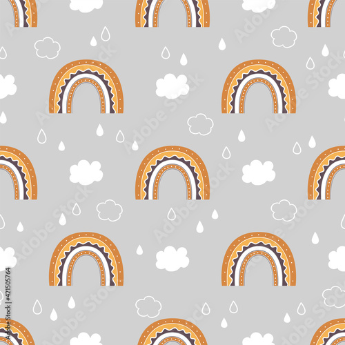 Cute childish seamless pattern with rainbow, clouds and rain in the sky.