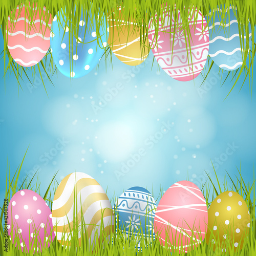 Easter background with eggs and grass and blue sky
