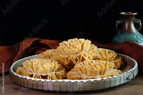 Crispy lotus Blossom Cookie (or Knanom Dok Jog)  famous Thai snacks. Selective focus with copy space photo