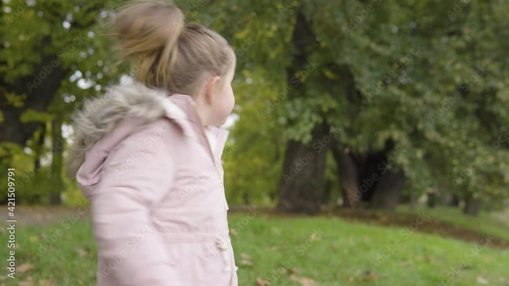 Cute little Caucasian girl looks around in a park - closeup Cute little Caucasian girl looks around in a park - closeup