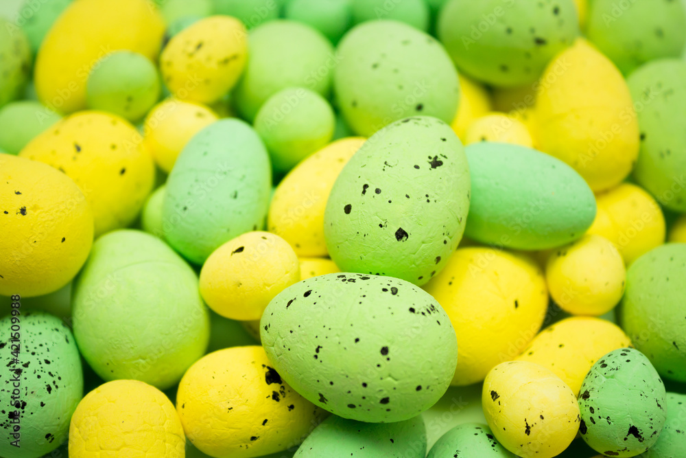 Yellow and green Easter eggs on the pile. Spring holidays concept