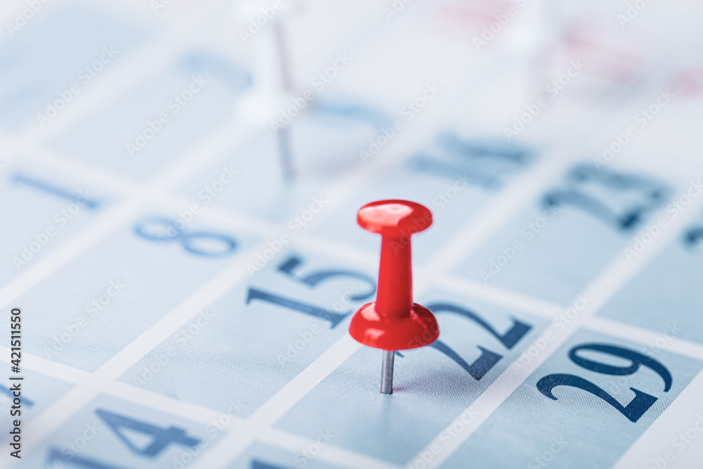 Calendar page for 2021, a month marked with an important date with a pin. chronology, time, concept Calendar page for 2021, a month marked with an important date with a pin. chronology, time, concept