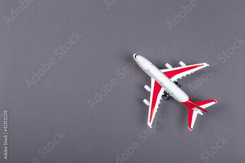 Airplane model with red wings. online ticket and tourism concept