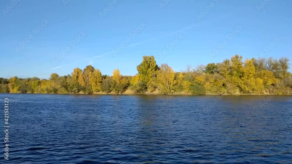 calm flow of the river on a clear day, along the banks of the river yellowing foliage of the autumn forest calm flow of the river on a clear day, along the banks of the river yellowing foliage of the autumn forest