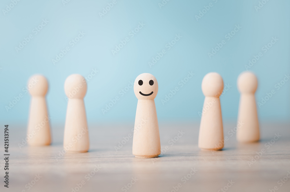 Wood person model among people Smiling .Successful team leader concept. Wood person model among people Smiling .Successful team leader concept.