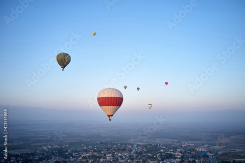 Colorful hot air balloons flying in the morning sky.