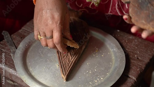 Woman making thekua by hand for chhath puja photo
