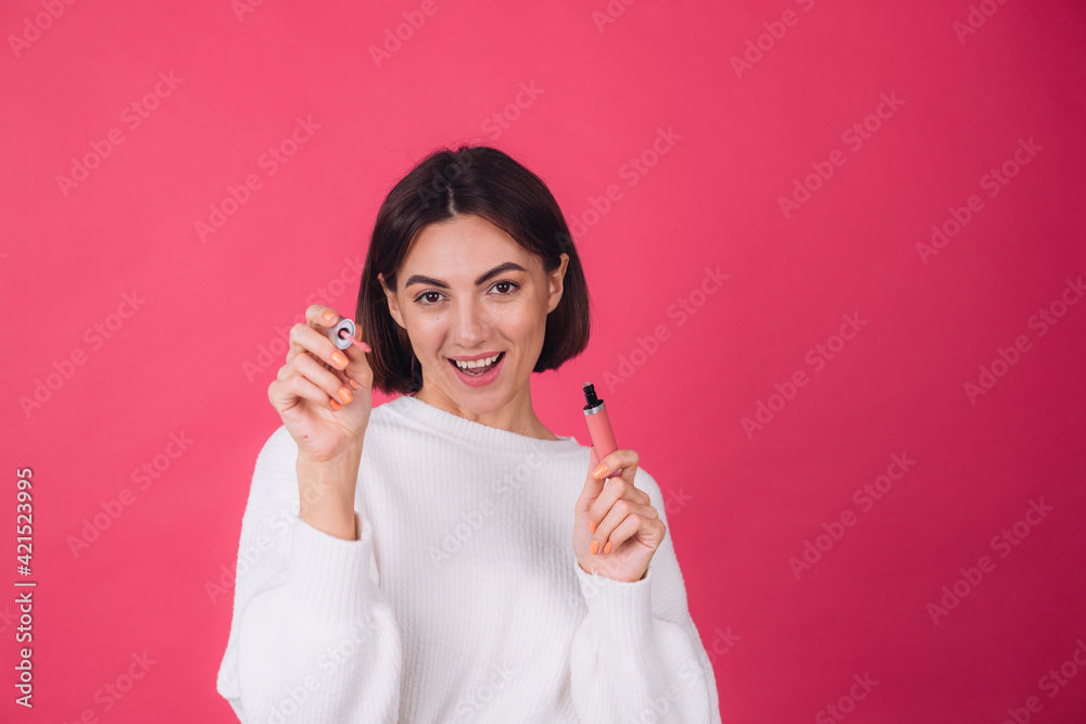 Stylish woman in casual white sweater on pink red background isolated space happy positive hold lipstick Stylish woman in casual white sweater on pink red background isolated space happy positive hold lipstick