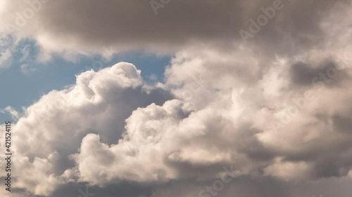 Time lapse of blue sky background with many layers of fluffy tiny stratus cirrus striped clouds. Windy weather  photo