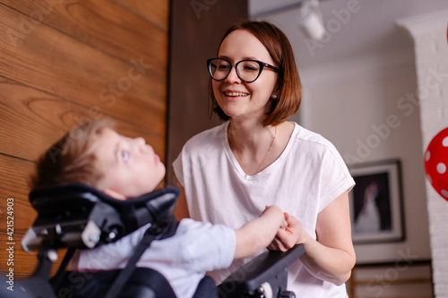 Mother of the child with cerebral palsy. Classes with a disabled person, the rehabilitation process. Heavy motherhood. Treatment is taking care of the child's health. Rehabilitation teacher.  Leisure
