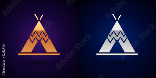 Gold and silver Traditional indian teepee or wigwam icon isolated on black background. Indian tent. Vector