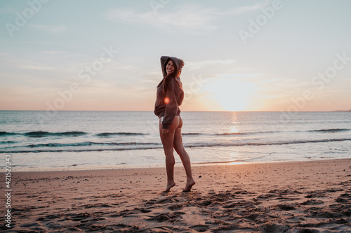 Smiling young woman at sunset beach © Jaime