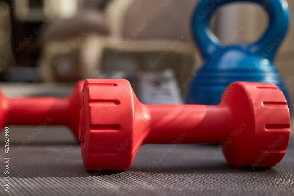 Fototapeta premium Fitness equipments at home. Focus on fitness tools, barbell and kettlebell. Concepts about home workout, fitness, sport and health.