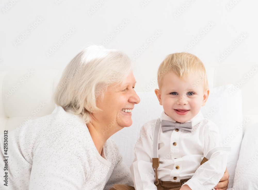 Happy good looking senior women with hir adorable grandson indoor. Happy good looking senior women with hir adorable grandson indoor.