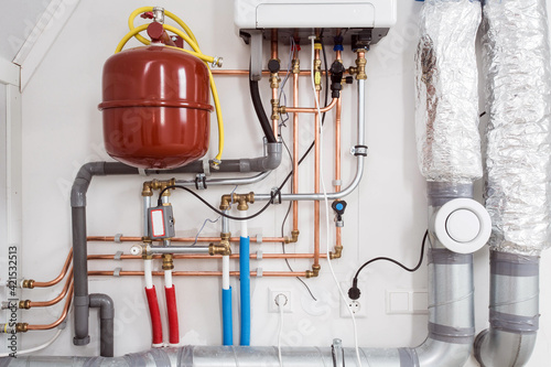 Heating installation and central boiler heating system on wall in house close-up