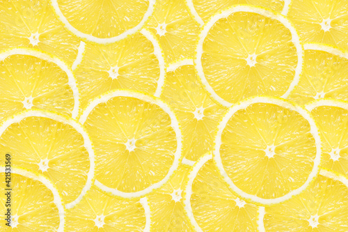 Yellow lemon slices background. Fruit pattern. Cut slices color texture. Lemon fruit section backdrop.