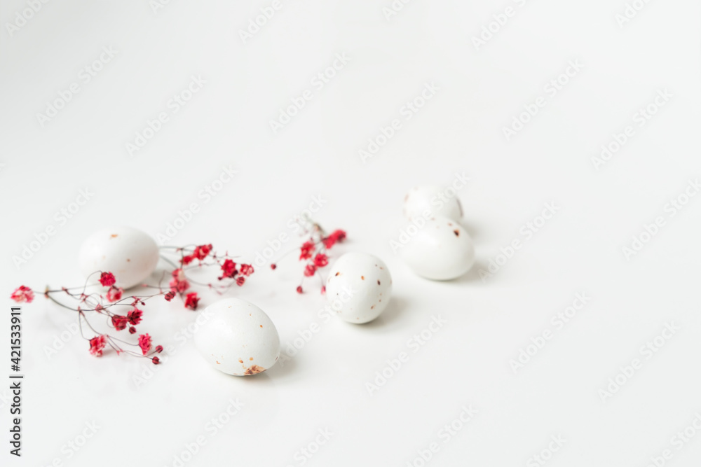 Easter minimal composition with eggs and flowers on the white background. Easter concept. Copy space. Easter minimal composition with eggs and flowers on the white background. Easter concept. Copy space.