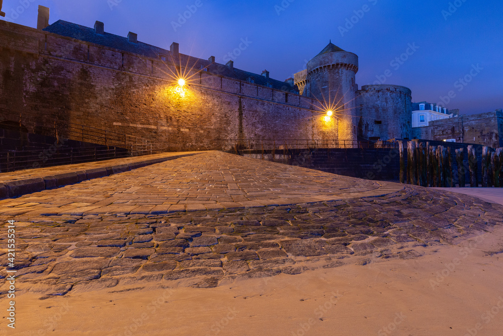 Saint-Malo. Old stone fortress wall at sunrise.