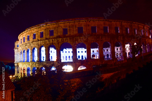 Night view of the ancient Roman amphitheater arena in Pula, one of the best preserved landmark of Croatia.
