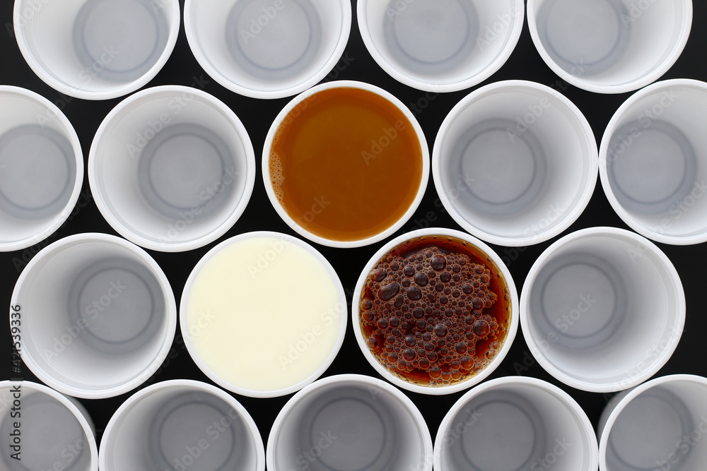 Coffee, tea and milk in white plastic disposable cups, view from above Coffee, tea and milk in white plastic disposable cups, view from above