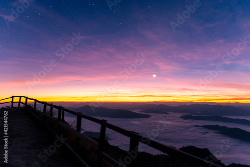 Landscape and starscape of the mountain and sea of mist in winter sunrise view from top of Phu Chi Dao mountain   Chiang Rai  Thailand