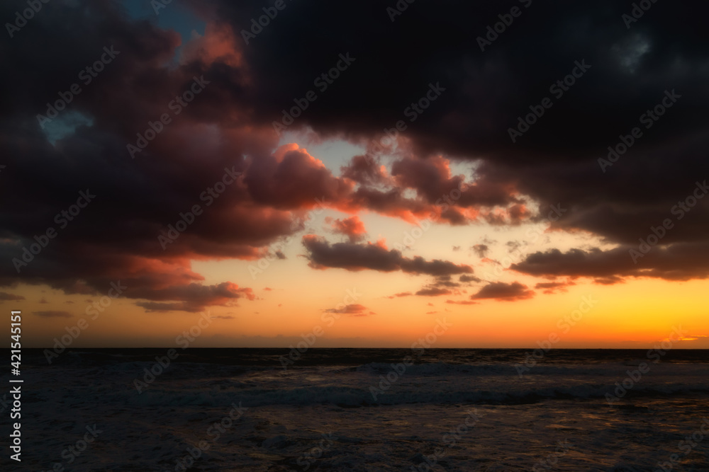 Cloudy sunset at the stormy sea.