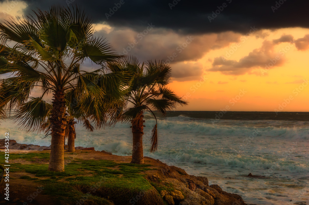 Cloudy sunset in the stormy sea on a tropical island.