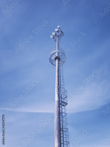 mast with spotlights on stadium at blue sky
