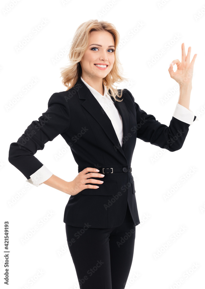 Happy smiling businesswoman in black suit, showing ok hand sign gesture, isolated against white background. Portrait image of confident business woman at studio. Happy smiling businesswoman in black suit, showing ok hand sign gesture, isolated against white background. Portrait image of confident business woman at studio.
