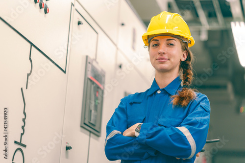 Portrait of young female electrical engineer in electrical control room