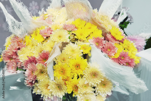 bouquet of yellow and pink chrysanthemums. A beautiful bouquet of bright flowers on a blurry background